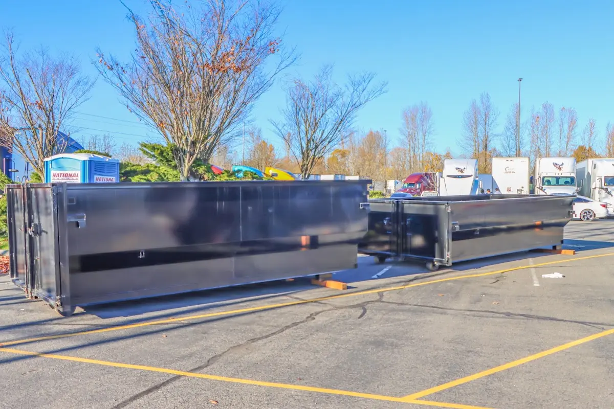 Professional dumpster rental service with roll-off container on residential driveway in Barrington